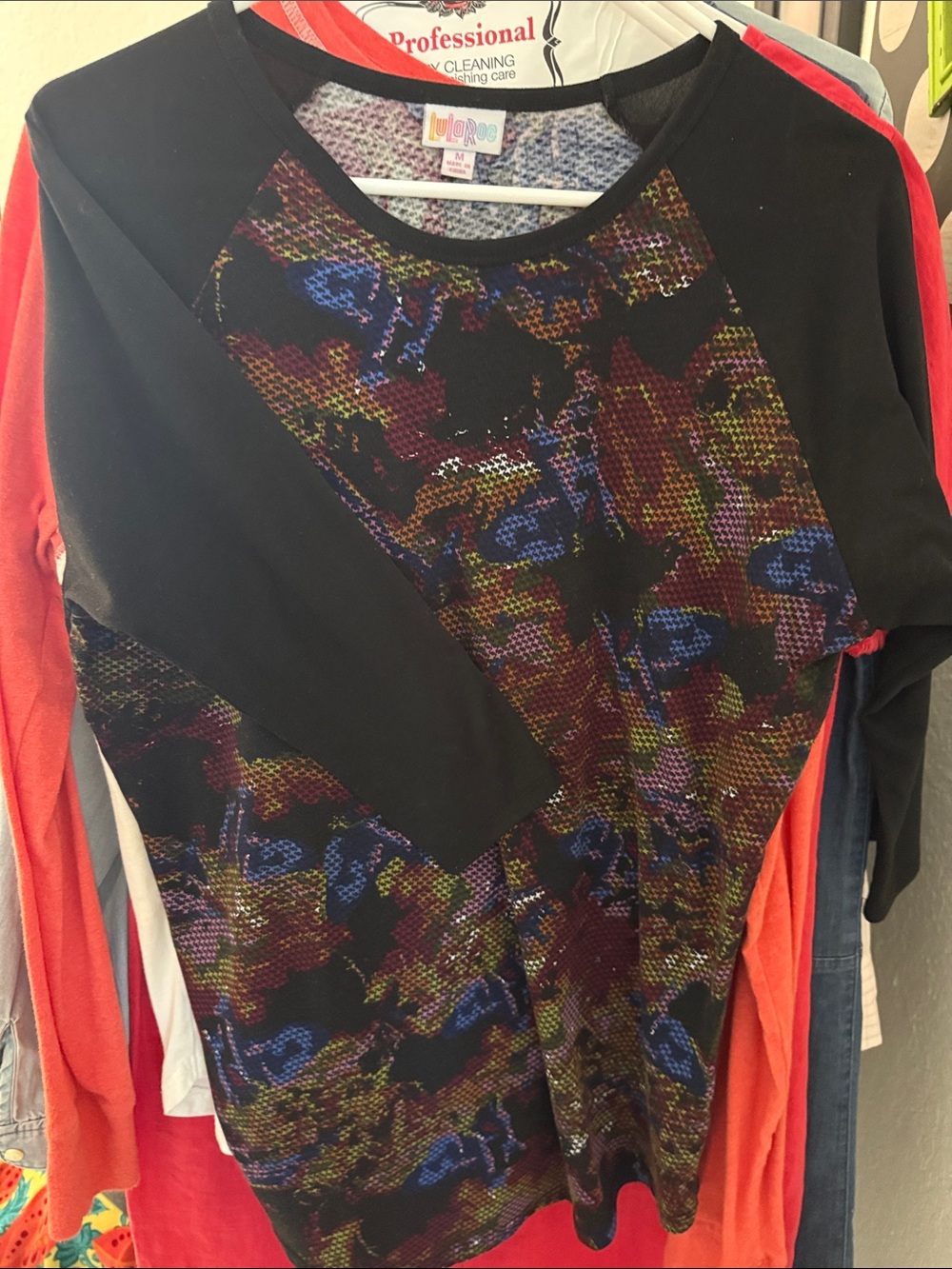 LuLaRoe Black Raglan Top with Multicolor Abstract Print